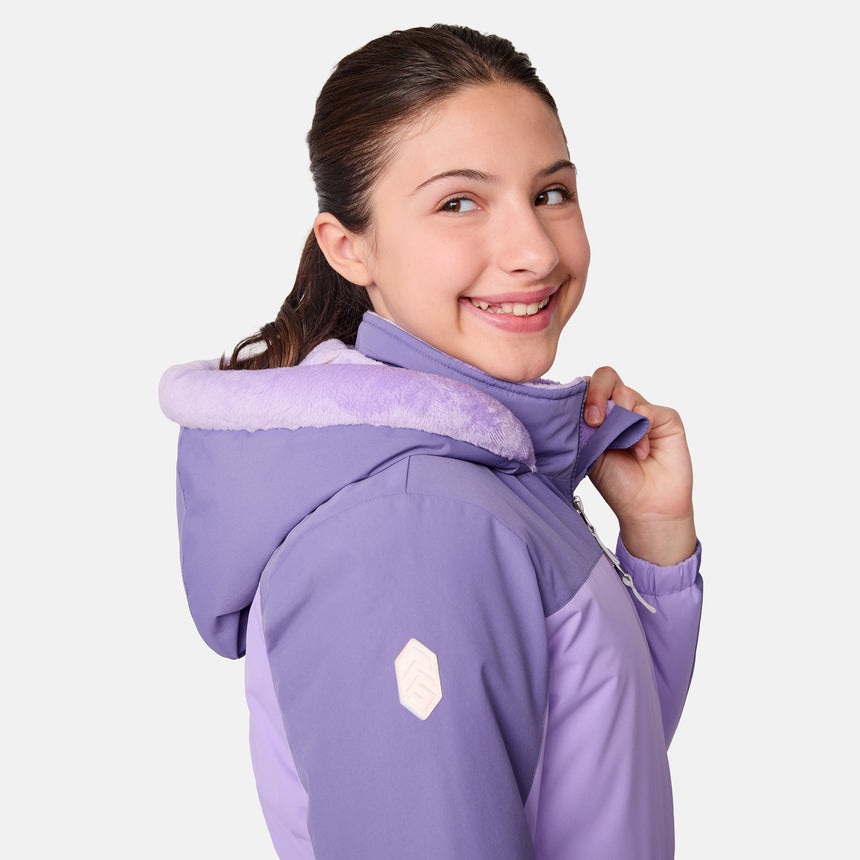 [Samantha is wearing size M.] Model wearing a Free Country color-blocked winter jacket in pink and navy, featuring a fuzzy-lined hood, zippered chest and hand pockets, and insulated design for cold-weather comfort. Paired with matching navy snow pants for outdoor adventures.