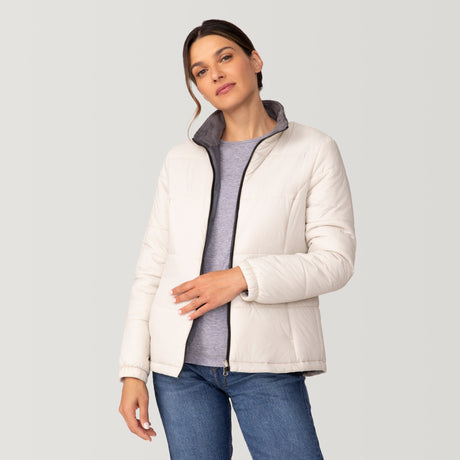 [Olga is 5’9” wearing a size Small.] Woman wearing Free Country Women's Back of Bell 3-in-1 Systems Jacket in black with a full front zipper opening, soft lining, attached hood with adjustable drawcords, and water resistant and wind resistant stretch performance fabric, inner puffer jacket, outer shell for weather, light grey background. Perfect women’s  jacket for fall weather.