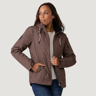 [Shelby is 5’9” wearing a size Small.] Woman wearing Free Country Women's Back of Bell 3-in-1 Systems Jacket in brown with a full front zipper opening, soft lining, attached hood with adjustable drawcords, and water resistant and wind resistant stretch performance fabric, inner puffer jacket, outer shell for weather, light grey background. Perfect women’s  jacket for fall weather.