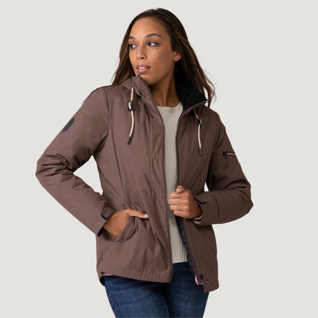 [Shelby is 5’9” wearing a size Small.] Woman wearing Free Country Women's Back of Bell 3-in-1 Systems Jacket in brown with a full front zipper opening, soft lining, attached hood with adjustable drawcords, and water resistant and wind resistant stretch performance fabric, inner puffer jacket, outer shell for weather, light grey background. Perfect women’s  jacket for fall weather.