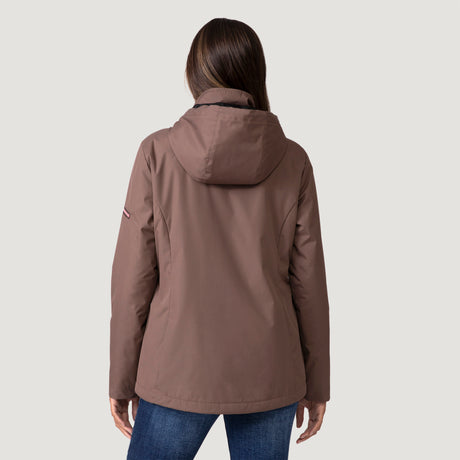 [Shelby is 5’9” wearing a size Small.] Woman wearing Free Country Women's Back of Bell 3-in-1 Systems Jacket in brown with a full front zipper opening, soft lining, attached hood with adjustable drawcords, and water resistant and wind resistant stretch performance fabric, inner puffer jacket, outer shell for weather, light grey background. Perfect women’s  jacket for fall weather.