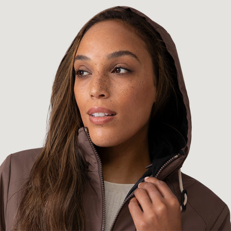 [Shelby is 5’9” wearing a size Small.] Woman wearing Free Country Women's Back of Bell 3-in-1 Systems Jacket in brown with a full front zipper opening, soft lining, attached hood with adjustable drawcords, and water resistant and wind resistant stretch performance fabric, inner puffer jacket, outer shell for weather, light grey background. Perfect women’s  jacket for fall weather.