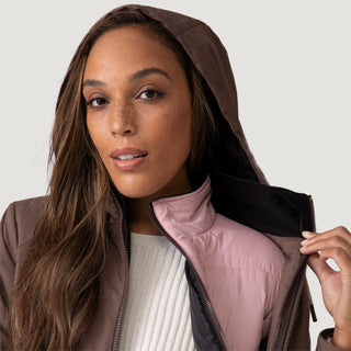 [Shelby is 5’9” wearing a size Small.] Woman wearing Free Country Women's Back of Bell 3-in-1 Systems Jacket in brown with a full front zipper opening, soft lining, attached hood with adjustable drawcords, and water resistant and wind resistant stretch performance fabric, inner puffer jacket, outer shell for weather, light grey background. Perfect women’s  jacket for fall weather.