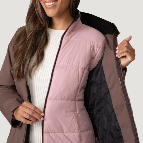 [Shelby is 5’9” wearing a size Small.] Woman wearing Free Country Women's Back of Bell 3-in-1 Systems Jacket in brown with a full front zipper opening, soft lining, attached hood with adjustable drawcords, and water resistant and wind resistant stretch performance fabric, inner puffer jacket, outer shell for weather, light grey background. Perfect women’s  jacket for fall weather.