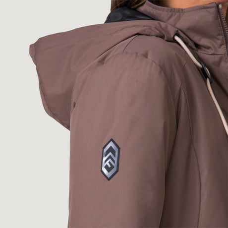 [Shelby is 5’9” wearing a size Small.] Woman wearing Free Country Women's Back of Bell 3-in-1 Systems Jacket in brown with a full front zipper opening, soft lining, attached hood with adjustable drawcords, and water resistant and wind resistant stretch performance fabric, inner puffer jacket, outer shell for weather, light grey background. Perfect women’s  jacket for fall weather.