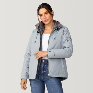 [Olga is 5’9” wearing a size Small.] Woman wearing Free Country Women's Back of Bell 3-in-1 Systems Jacket in light blue with a full front zipper opening, soft lining, attached hood with adjustable drawcords, and water resistant and wind resistant stretch performance fabric, inner puffer jacket, outer shell for weather, light grey background. Perfect women’s  jacket for fall weather.