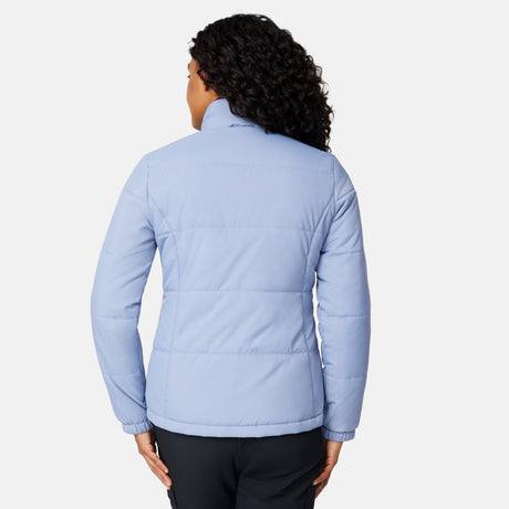 A person with curly hair is seen from the back wearing the Free Country Women's Back of Bell 3-in-1 Systems Jacket in light blue and black pants, standing against a plain white background.
