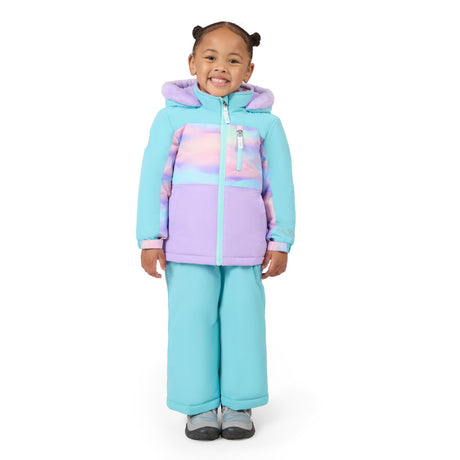 A young child wearing a light blue and lavender hooded snowsuit with pastel tie-dye panels on the chest, standing against a plain white background.