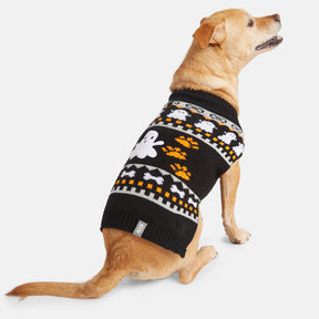 A light brown dog, facing left and looking up, wears the Clearance Dog Halloween Sweater—a black pullover with ghosts, orange paw prints, and geometric designs—showcasing its festive holiday style.