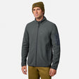 [Model is wearing size M.] A man wearing a dark gray full-zip fleece jacket with a stand-up collar, zippered hand pocket, and a dark gray sleeve pocket, paired with a brown beanie and olive pants, against a light gray background.