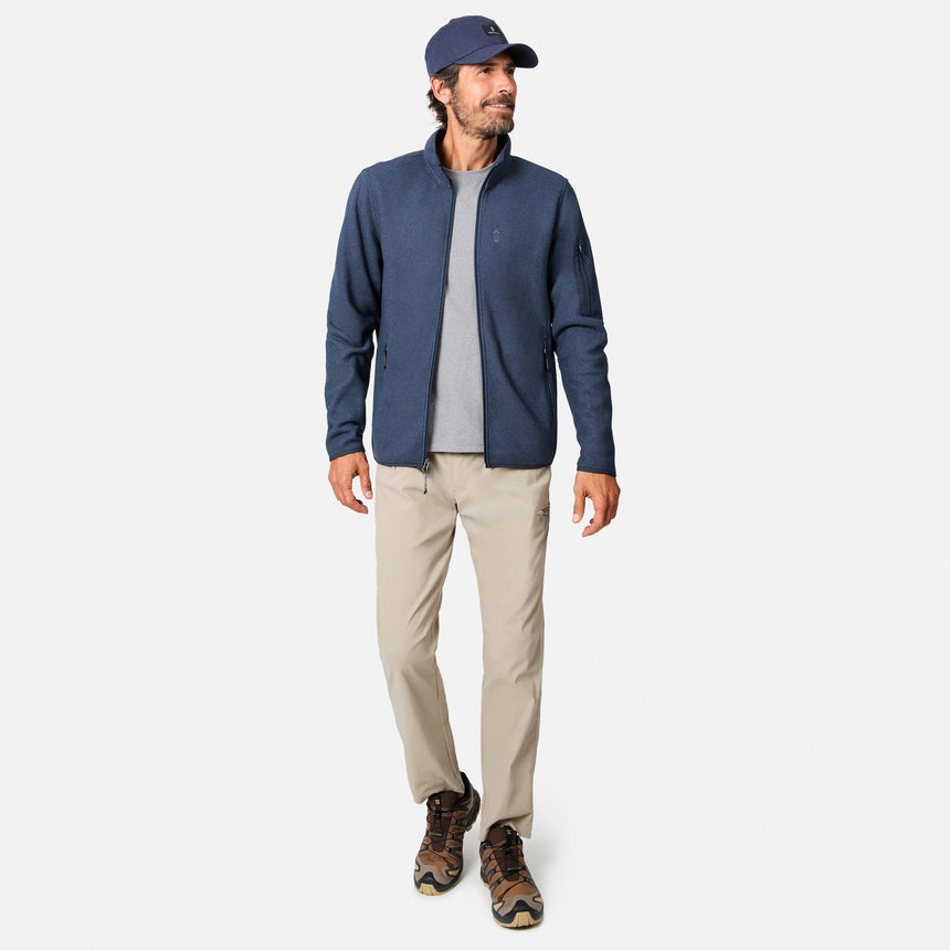 [Model is wearing size M.] A man modeling a navy blue quarter-zip fleece jacket, worn over a gray t-shirt with beige pants and brown hiking boots, on a light gray background.