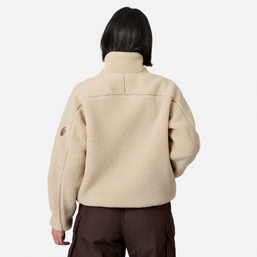 [Model is wearing size S.] A person shown from the back wearing a beige sherpa fleece pullover jacket and dark brown pants against a light gray studio background.