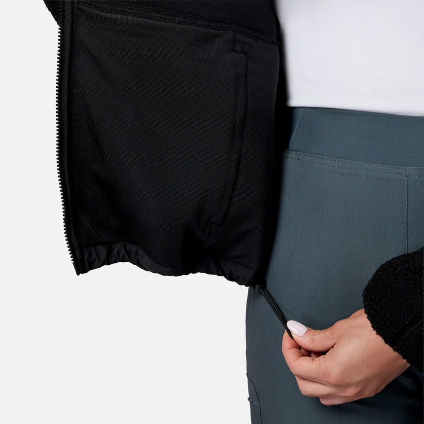 [Model is wearing size S.] Close-up of a person wearing black zippered shorts or a skirt and slate blue-gray athletic pants, with a hand pulling the zipper tab.