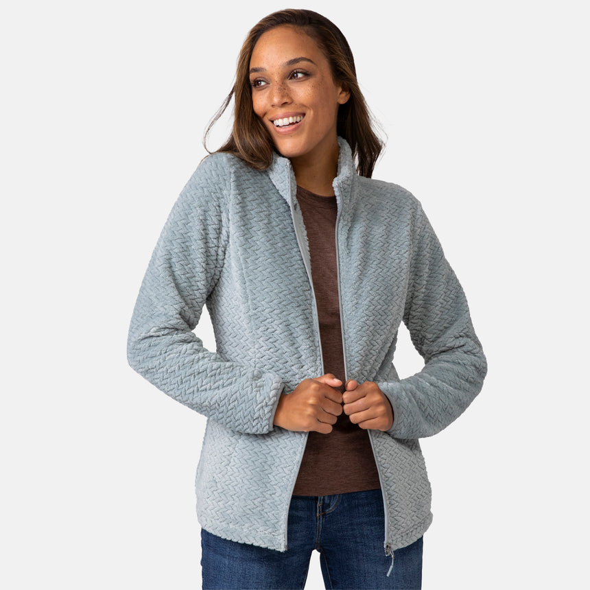 Woman wearing a green quilted fleece jacket on a white background