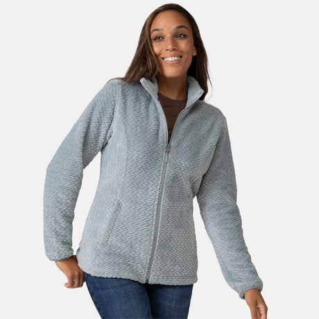 Woman wearing a green quilted fleece jacket on a white background