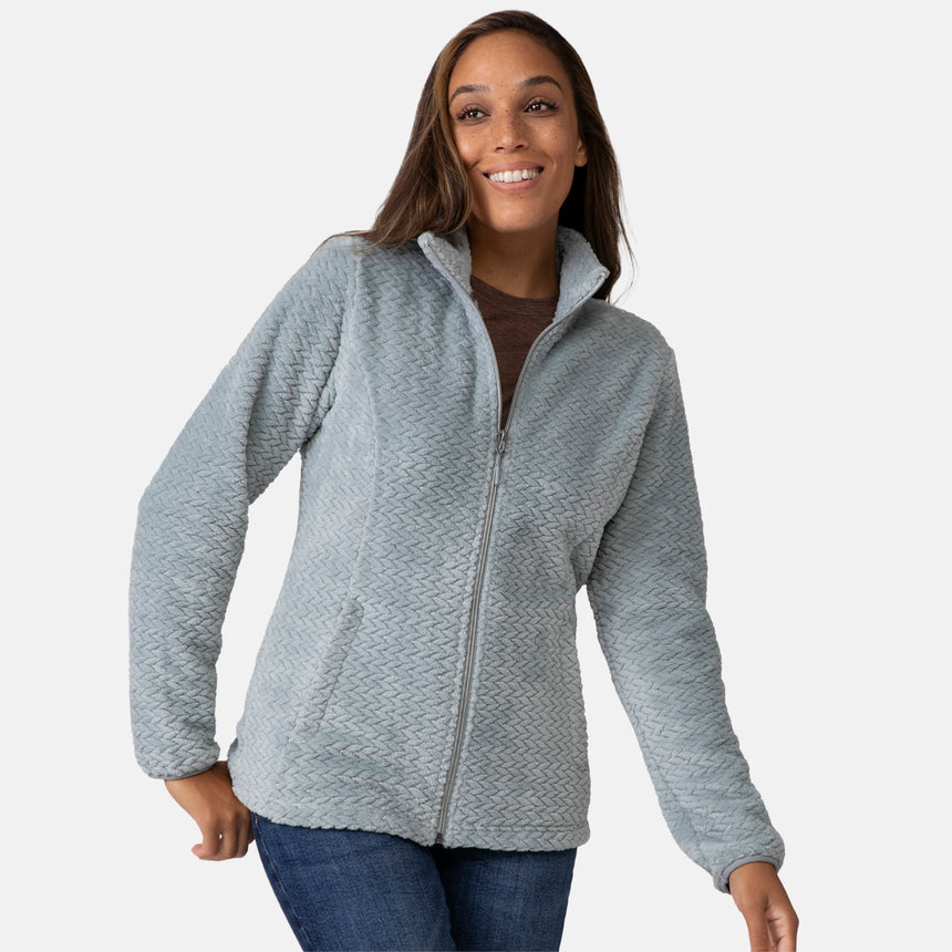 Woman wearing a green quilted fleece jacket on a white background