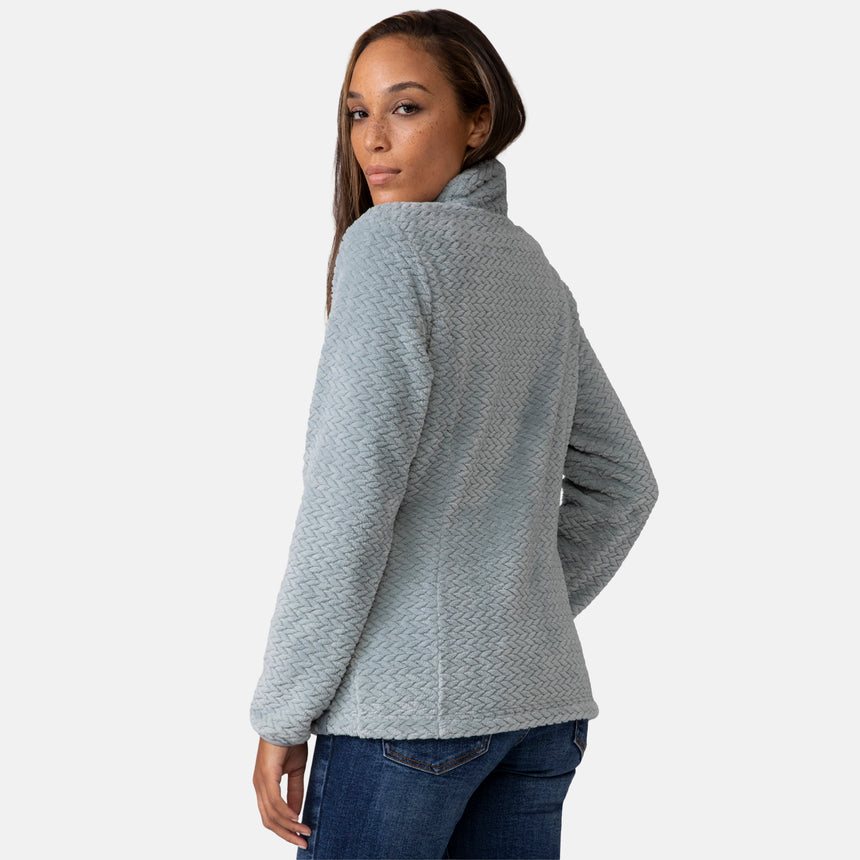 Woman wearing a green quilted fleece jacket on a white background