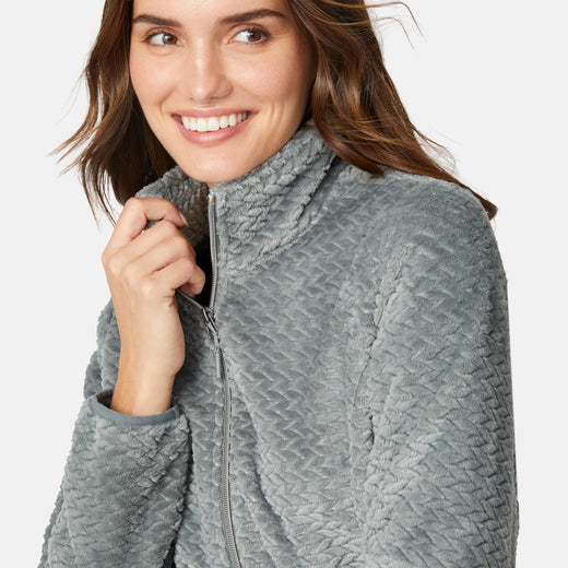 [Jessica is 5'9.5" wearing size S.] Woman wearing a green quilted fleece jacket on a light gray background