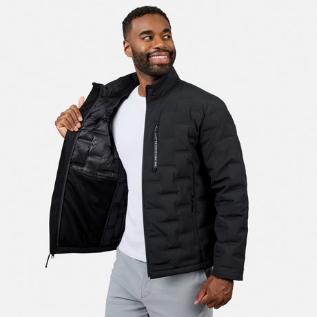 [Model is wearing size M.] A man wearing a black puffer jacket over a white t-shirt and light gray pants, holding the jacket open to show the interior lining against a light gray background.