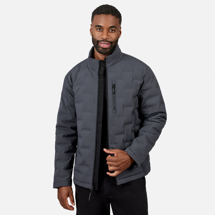 [Model is wearing size M.] A man wearing a dark gray puffer jacket with a black front zipper and a vertical zippered pocket on the chest, paired with black pants, against a light gray background.