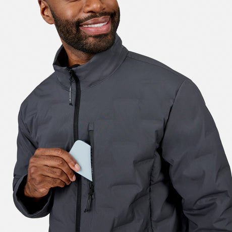 [Model is wearing size M.] A close-up of a man wearing a dark gray zip-up jacket, holding a light blue card near the zipper pocket on his chest, against a clean light gray background.