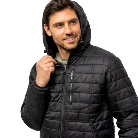 A man smiles and looks to the side, holding the hood of a partially zipped Men's FreeCycle® Brick Puffer+ Jacket by Clearance. The black jacket features a Sherpa lining and is set against a white background.