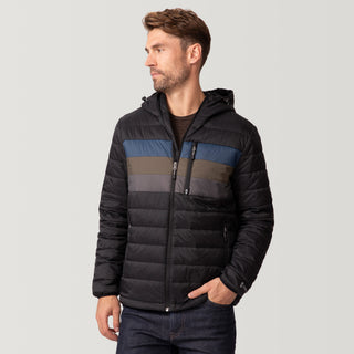 [Matt is 6'2" wearing a size Medium.] Man wearing the Free Country Men's Tri-Color Hooded Puffer Jacket in black with horizontal stripes in blue, brown, and grey, standing against a plain light background.
