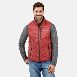 [Justin is 6'1" wearing a size Medium.] Man wearing the Free Country Men's FreeCycle® Stimson Puffer Vest in red, featuring quilted design, REPREVE® poly fill, and a vertical zip, layered over a grey long-sleeve shirt with light jeans.