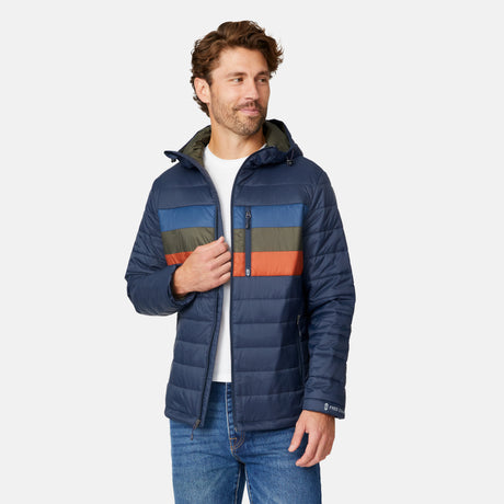 [Matt is 6'2" wearing size M.] Men’s Free Country zip-front puffer jacket in navy with multicolored horizontal chest stripes—featuring full-length zipper closure, insulated design, and classic hood-free silhouette. Paired with a white shirt and blue jeans for a vibrant, cold-weather look with retro-inspired flair.