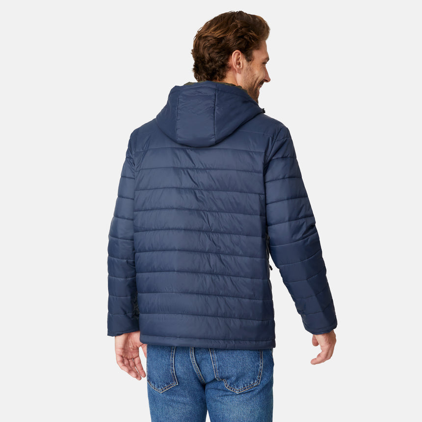 [Matt is 6'2" wearing size M.] Men’s Free Country zip-front puffer jacket in navy with multicolored horizontal chest stripes—featuring full-length zipper closure, insulated design, and classic hood-free silhouette. Paired with a white shirt and blue jeans for a vibrant, cold-weather look with retro-inspired flair.