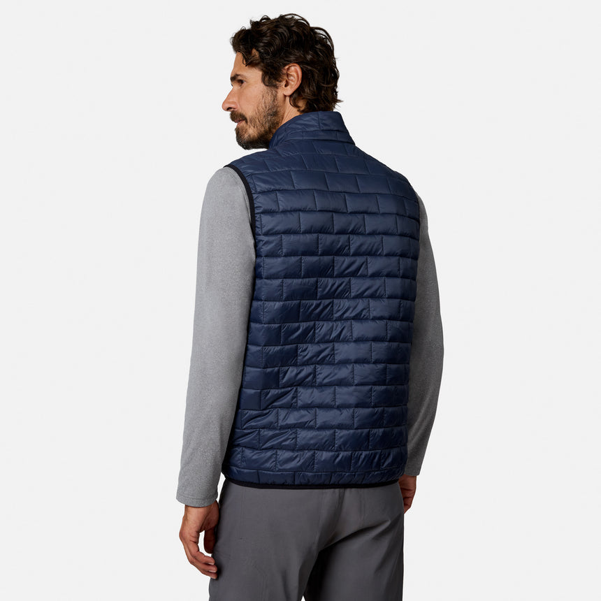 [Model is wearing size M.] A man wearing a navy blue quilted puffer vest over a gray long-sleeve shirt, shown from the back against a light gray studio background.