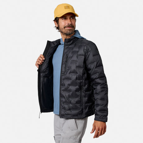 [Model is wearing size M.] A man wearing a black hooded puffer jacket over a light blue shirt and gray pants, with a yellow cap, photographed against a light gray studio background.
