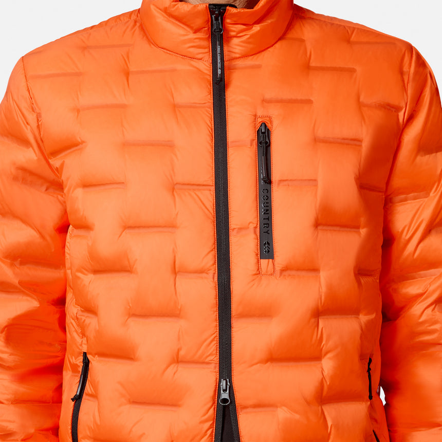 [Model is wearing size M.] Bright orange puffer jacket with black zippers, featuring a high collar, horizontal quilted baffles, and a vertical zippered pocket on the chest.
