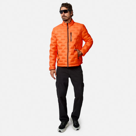 [Model is wearing size M.] A man wearing a bright orange quilted puffer jacket, black cargo pants, and black sneakers, standing against a light gray studio background.
