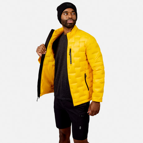 [Model is wearing size M.] A man wearing a bright yellow quilted puffer jacket, black beanie, and black cargo shorts, standing against a light gray studio background with the jacket open.
