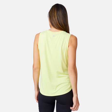 A woman with long brown hair, seen from behind, wears the Clearance Women's Microtech® Chill B Cool Curved Hem Tank Top in light yellow and black leggings against a plain white background.