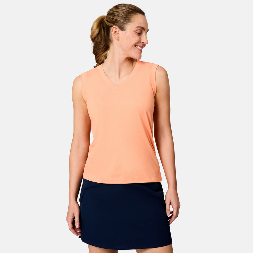 [Brooke is 5'9" wearing size S] Woman wearing a peach sleeveless top and navy skirt on a light gray background
