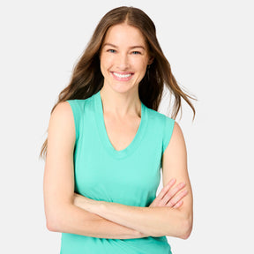 [Kaitlyn is 5'9" wearing size S] Woman wearing a green sleeveless top with arms crossed on a light gray background