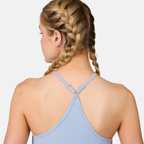 A woman with blonde hair in two French braids is seen from behind, wearing the Free Country Women's Microtech® Chill B Cool V-Neck Cami Top with Built-In Bra against a plain white background.