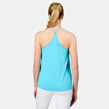 A woman with blond hair in a ponytail is seen from the back, wearing the Free Country Women's Microtech® Chill B Cool V-Neck Cami Top with Built-In Bra in light blue and white pants, standing against a plain white background.