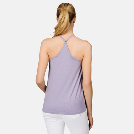 A woman with blond hair in a ponytail is shown from the back, wearing the Free Country Women's Microtech® Chill B Cool V-Neck Cami Top with Built-In Bra in light purple and white pants, standing against a plain white background.