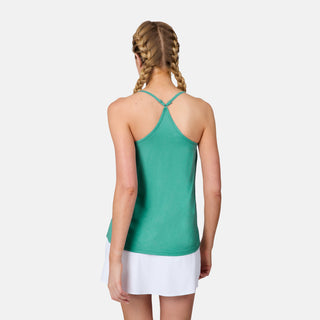 A woman with blonde braided hair is seen from the back, wearing a green Free Country Women's Microtech® Chill B Cool V-Neck Cami Top with Built-In Bra and a white skirt against a plain white background.