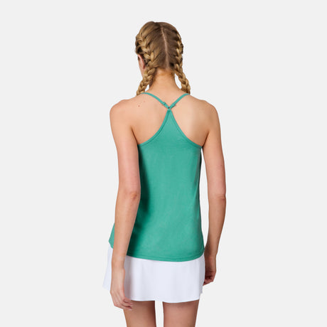 A woman with blonde braided hair is seen from the back, wearing a green Free Country Women's Microtech® Chill B Cool V-Neck Cami Top with Built-In Bra and a white skirt against a plain white background.