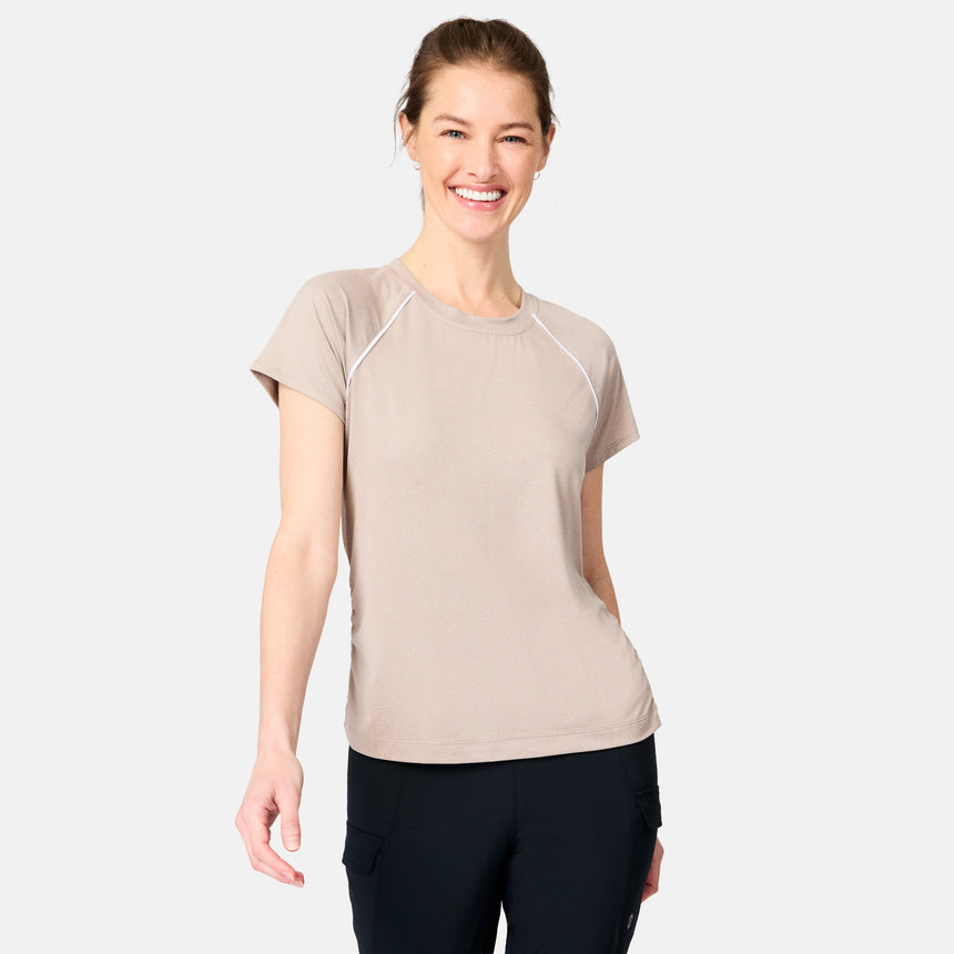 [Kaitlyn is 5'9" wearing size S] Woman wearing a beige athletic shirt and black pants on a white background