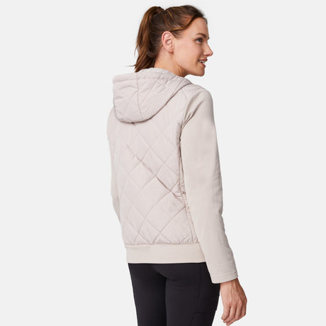 [Emily is 5'9" wearing size S.] Women’s light-colored quilted jacket with diamond-pattern stitching, zip-front closure, hood, and zippered pockets—layered over a white long-sleeve shirt and styled with black pants for a casual, cool-weather look.