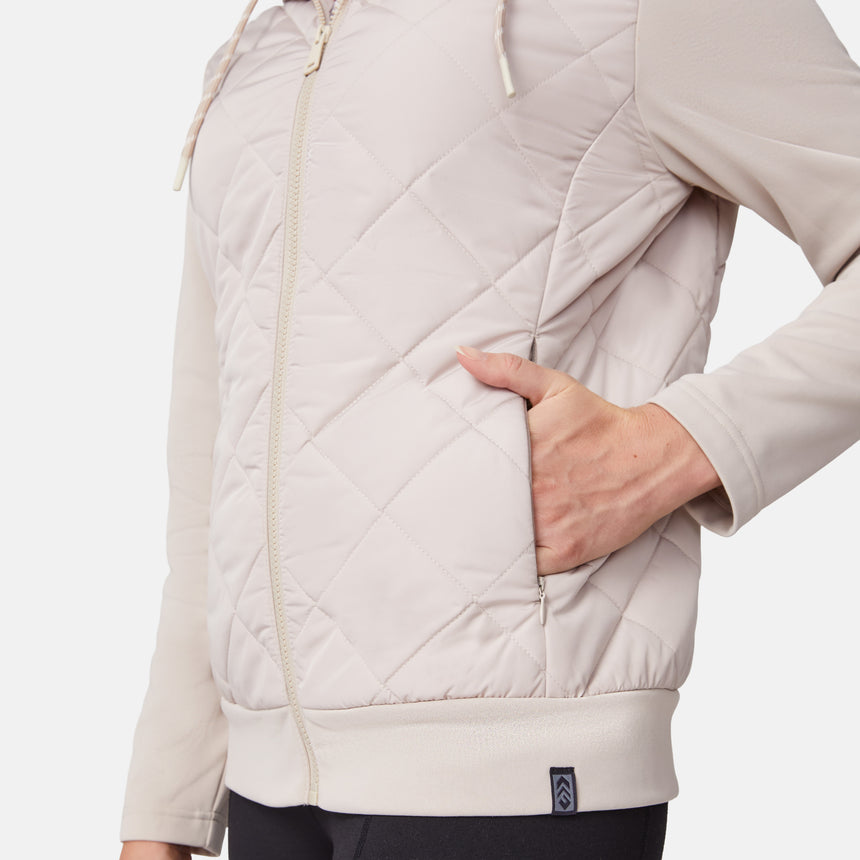 [Emily is 5'9" wearing size S.] Women’s light-colored quilted jacket with diamond-pattern stitching, zip-front closure, hood, and zippered pockets—layered over a white long-sleeve shirt and styled with black pants for a casual, cool-weather look.