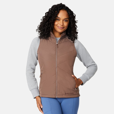 [Angelique is 5'10" wearing size S.] Woman wearing a brown quilted vest over a gray long-sleeve shirt on a white background