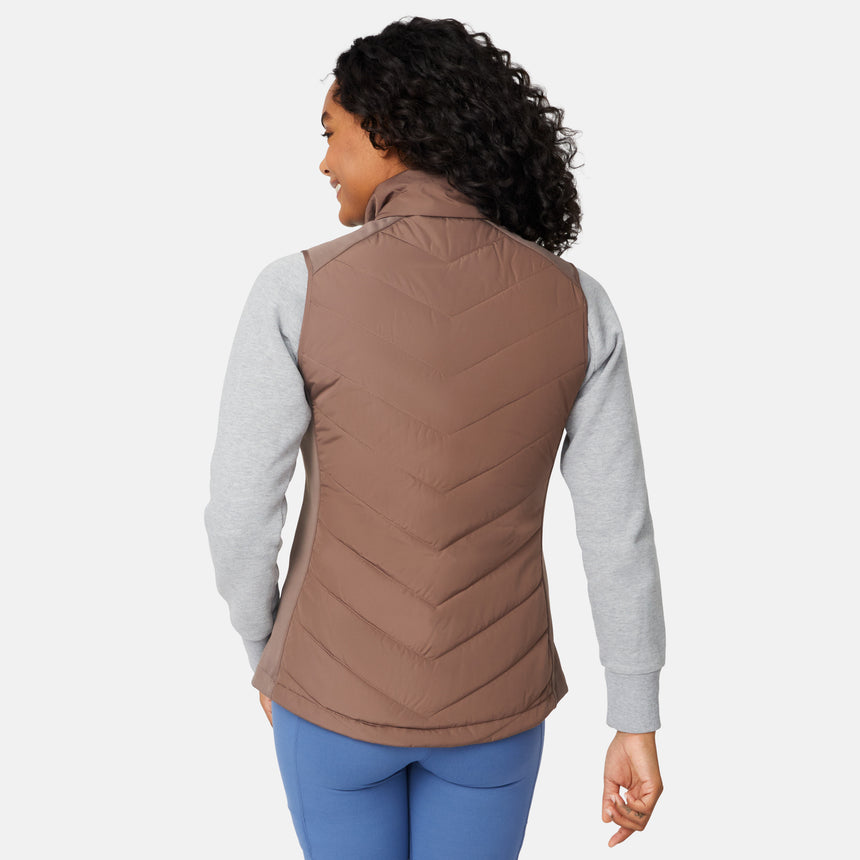 [Angelique is 5'10" wearing size S.] Woman wearing a brown quilted vest over a gray long-sleeve shirt on a white background