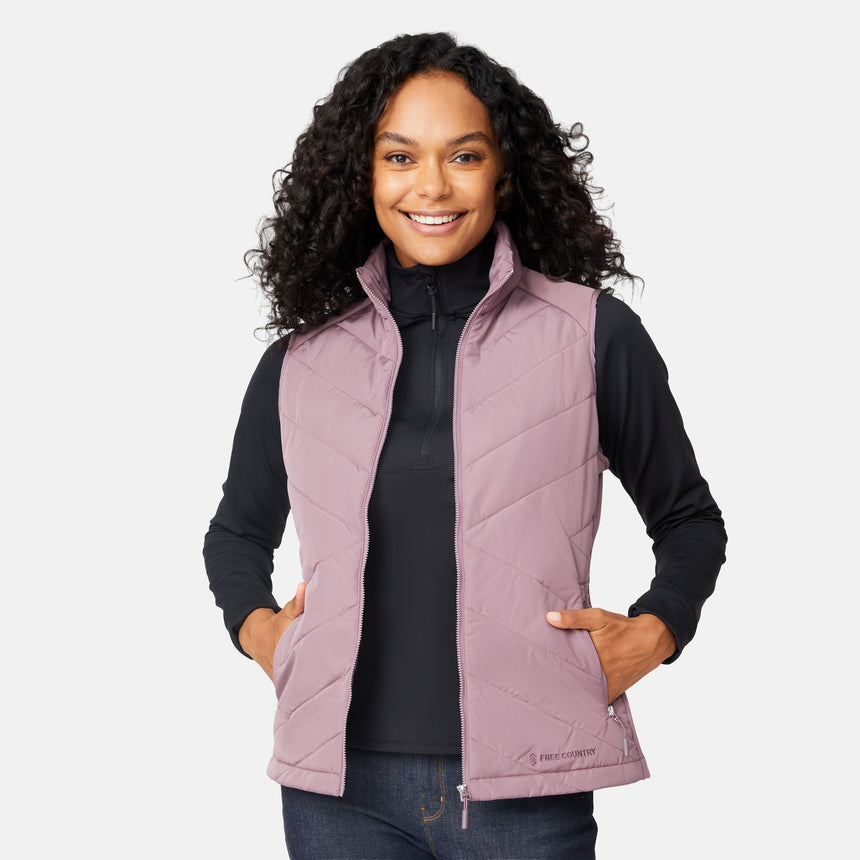 [Angelique is 5'10" wearing size S.] Woman wearing a purple quilted vest over a black long-sleeve shirt on a white background