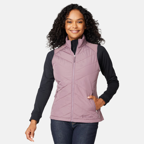 [Angelique is 5'10" wearing size S.] Woman wearing a purple quilted vest over a black long-sleeve shirt on a white background